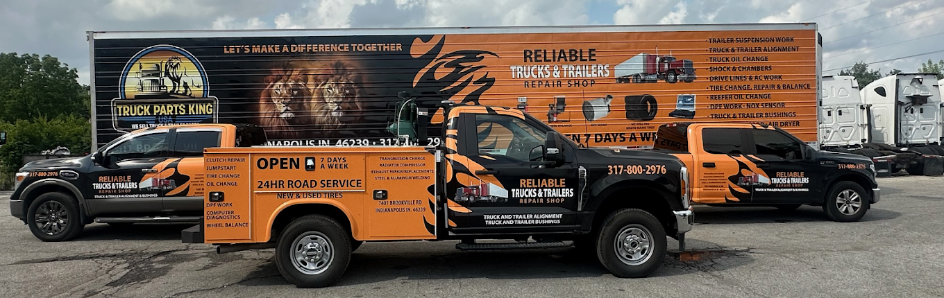 Reliable Truck and Trailer Repair branded service vehicles outside the shop