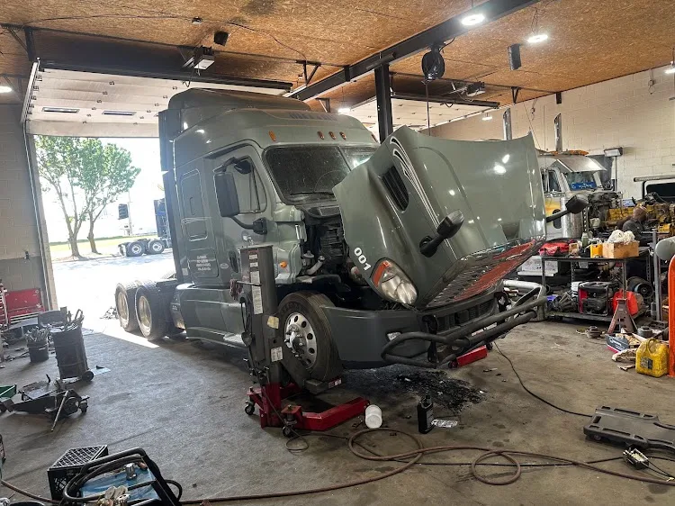 Heavy-duty semi truck being repaired inside the shop