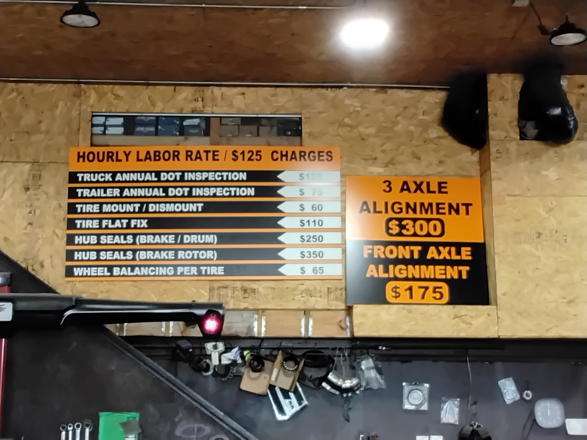Posted service pricing board at Reliable Truck and Trailer Repair